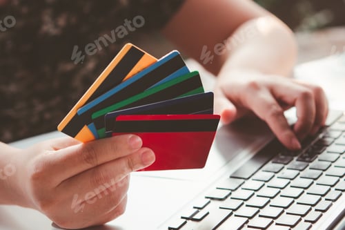 Preview: Credit card payment. Woman hands holding credit card and using laptop. Online shopping