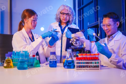 Preview: Two Asian men and women sit at a table in a laboratory, conducting research on liquids. They use