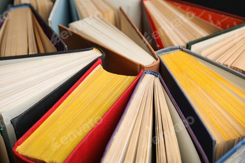 Preview: Stack of hardcover books as background, closeup