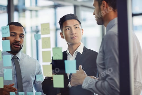 Preview: Shot of a group of young businesspeople having a brainstorming session together in a modern office