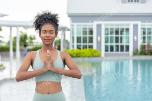 Preview: African Black healthy woman doing Yoga outdoor pool for good living home leisure lifestyle concept