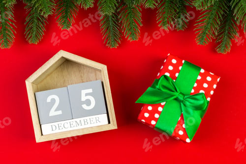 Preview: Top view of wooden calendar, gift box and fir tree on colorful background.