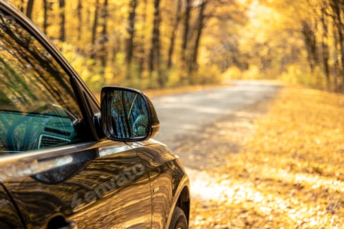 Preview: Rear view side mirror of a car. Seen through the rear view mirror.