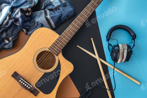 Preview: Music background with guitar and drumsticks, top view.