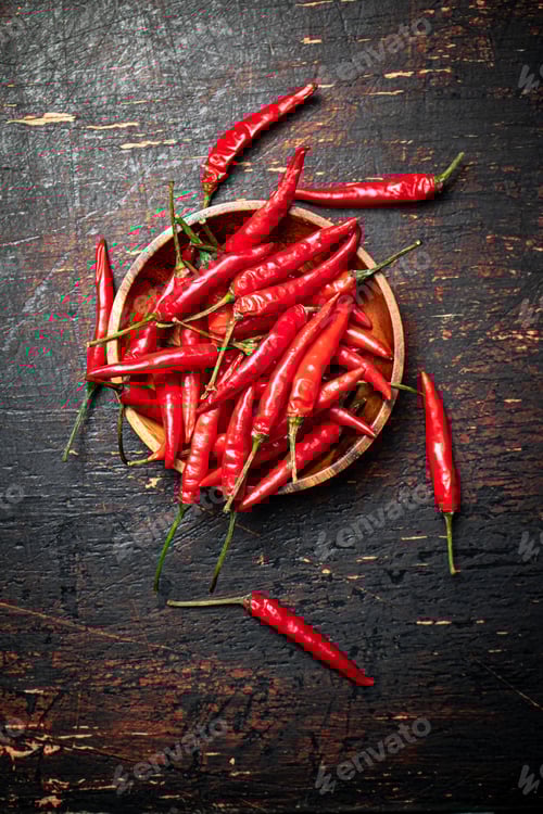 Preview: Wooden plate with hot chili peppers.