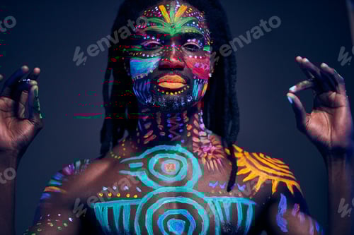 Preview: luminous portrait of young man in the UV rays on dark background