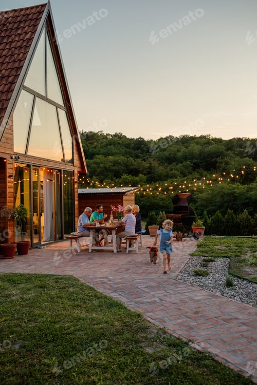 Preview: Girl and her dog is playing beside her family who having dinner in the backyard