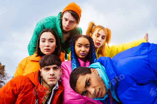 Preview: Multiracial group of young friends meeting outdoors in winter