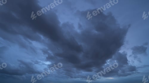 Preview: Sunset sky. Abstract nature background. Dramatic blue and orange, colorful clouds at twilight time.