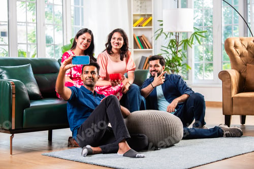 Preview: Indian asian young couple taking selfie using smartphone at home