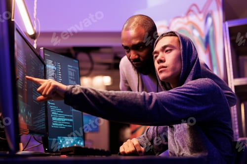 Preview: Hacker pointing at malware on screen