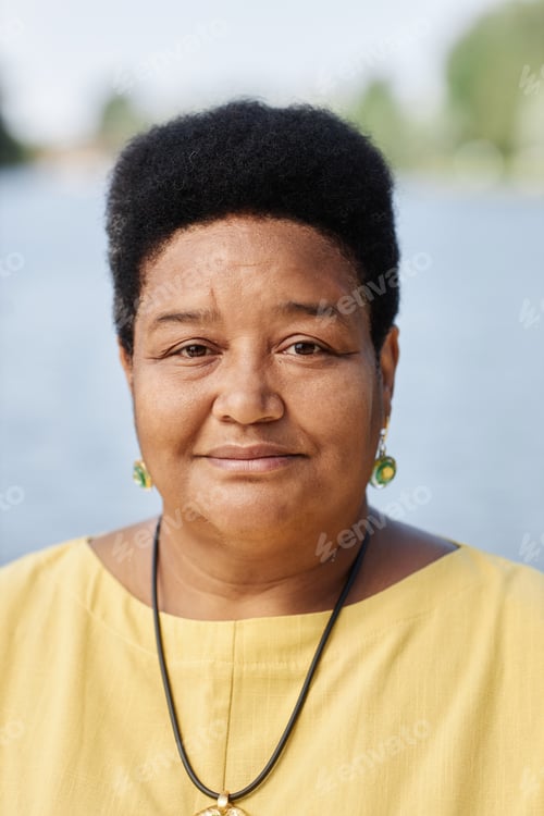 Preview: Close up senior Black woman looking at camera outdoors
