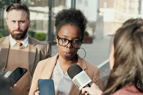 Preview: Woman being interviewed outdoors