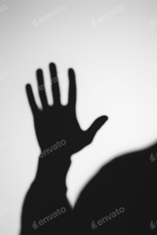 Preview: strange blurry shadow of human hand on grey