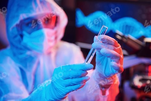 Preview: Nurse in mask and white uniform, holding tube with liquid and sitting in neon lighted laboratory