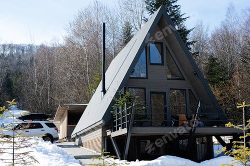 Preview: Wooden triangle country tiny cabin house and suv car with roof rack in mountains. Soul weekends.