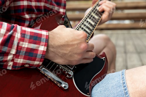 Preview: A man plays a beautiful guitar close-up