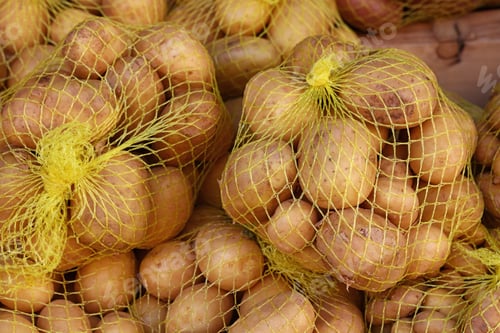 Preview: Close up heap of new potato at retail display