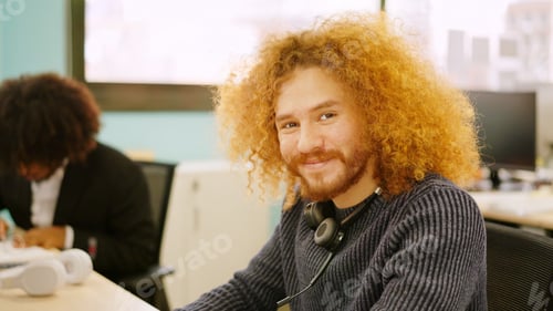 Preview: Modern man smiling while working in coworking space