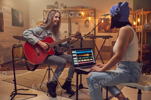 Preview: Two young women recording new music in studio