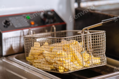 Preview: Closeup shot of fries in a fryer