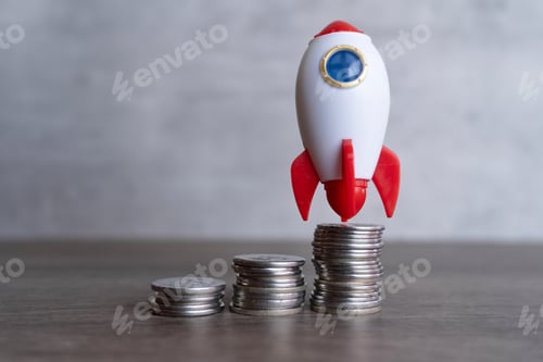 Preview: Closeup image of rocket spaceship and coins.