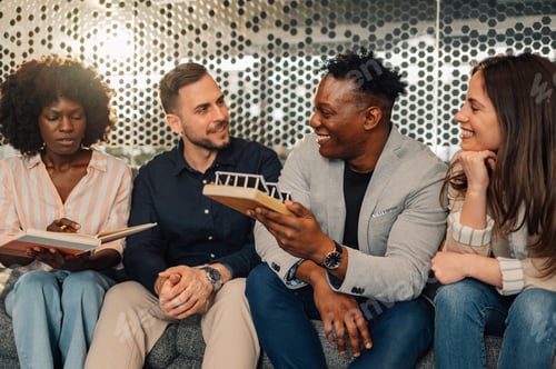 Preview: Diverse team with solar panel model representing sustainable ideas.