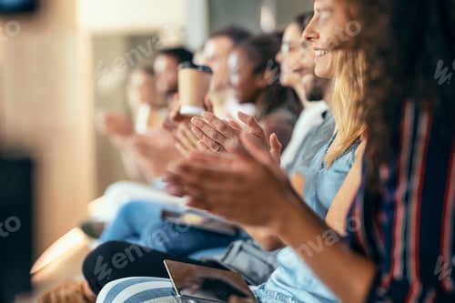 Preview: Happy business team clapping after listening the conference while sitting on coworking space.