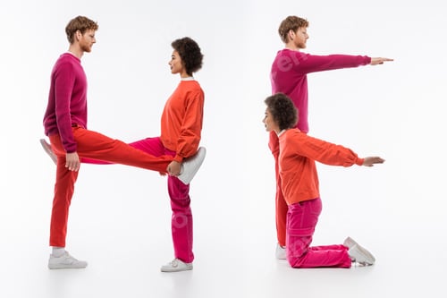 Preview: side view of multiethnic couple in magenta color clothes showing he word with legs and hands on