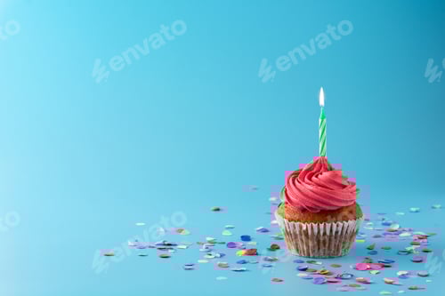 Preview: Pink birthday cupcake with green candle and colorful confetti