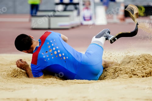 Preview: para-athlete long jump, landing in sand at athletics competition, summer sports games