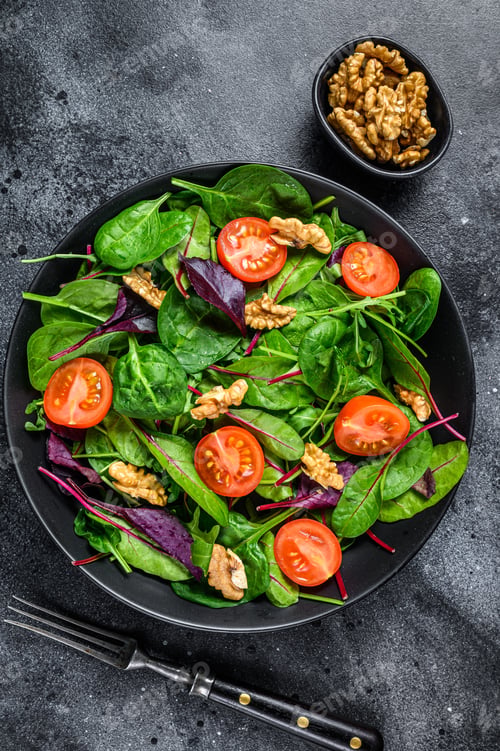 Preview: Vegetarian salad with mix leaves mangold, swiss chard, spinach, arugula and nuts in a salad bowl.