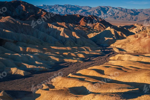 Preview: Golden hour light washing over a textured desert landscape