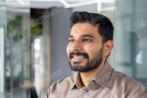 Preview: Confident young man smiling in a modern office setting