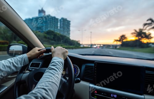 Preview: People driving car on sunrise city road