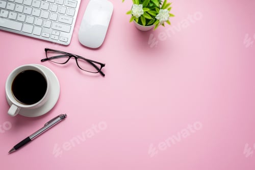 Preview: Desk with glasses notebook keyboard placed on pink table, copy space.