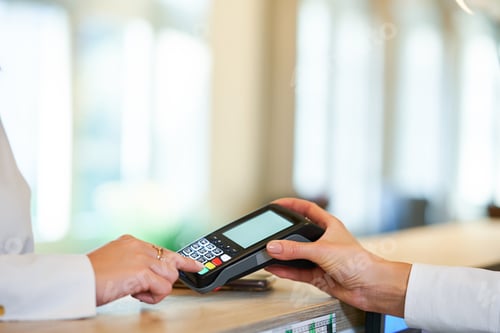 Preview: Receptionist and businesswoman at hotel front desk