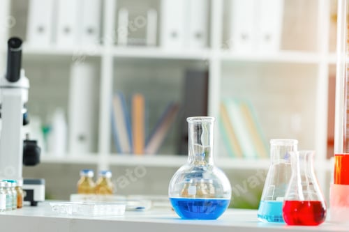 Preview: Microscope on the table with glassware in laboratory