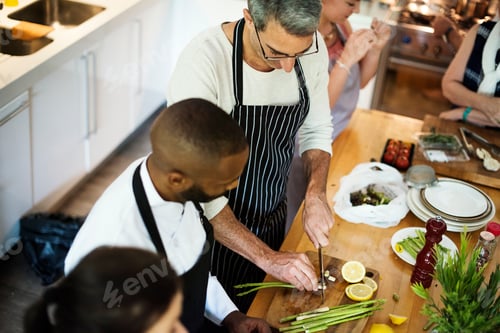 Preview: Group of friends cooking in the kitchen