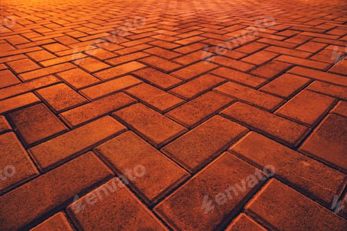 Preview: Texture of orange brick pavement in perspective as background.