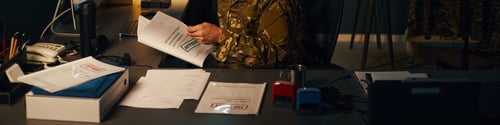 Preview: Reviewing Business Documents at Office Desk with Technology