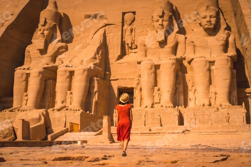 Preview: A Young Tourist In A Red Dress Entering The Abu Simbel Temple In Southern Egypt In Nubia Next To