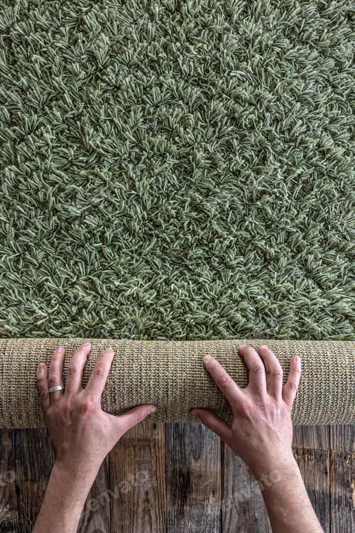 Preview: Background of texture of a green carpet with long pile on wooden floor.