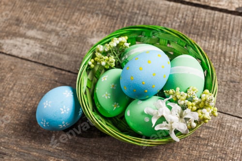 Preview: Easter eggs in nest on color wooden background