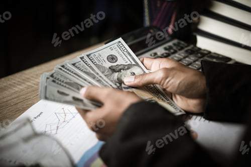 Preview: Close up,Hands of businesswoman
holding dollar