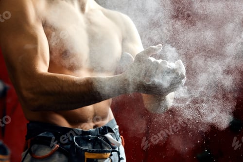 Preview: Man coating his hands in powder chalk magnesium preparing to climb, motion