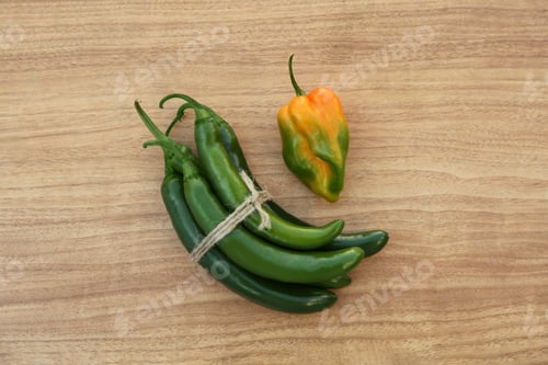 Preview: Different fresh ripe peppers on wooden table, flat lay