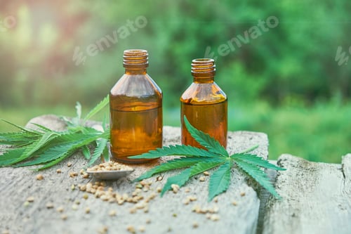 Preview: hemp leaves on wooden background, seeds, cannabis oil extracts in jars