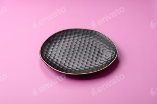 Preview: An empty round ceramic plate on a pink background as a kitchen utensil. An empty plate