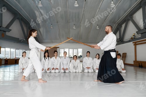 Preview: Martial arts master teaching young student to fight with wooden sword